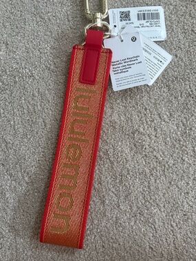 Lululemon Never Lost Keychain Metallic Wardmark - Lunar New Year NWT Oxford red